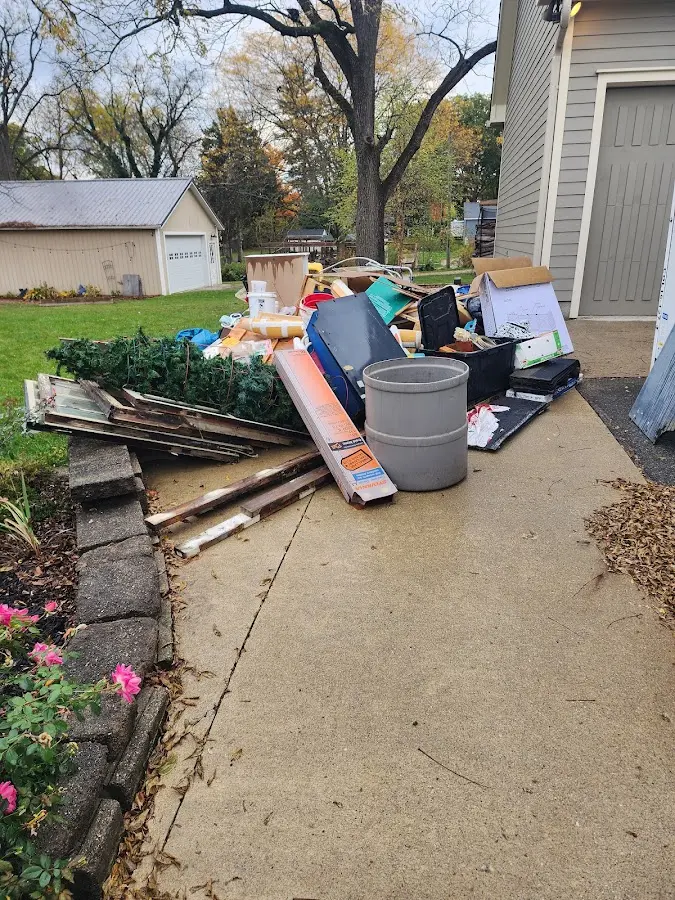 Dumpster being loaded with debris for Roofing Dumpster Rental in Seabrook